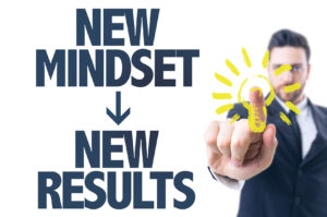 Business man pointing the text: New Mindset New Results