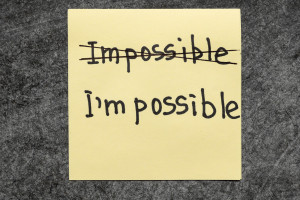 impossible - I am possible concept handwritten on yellow paper note